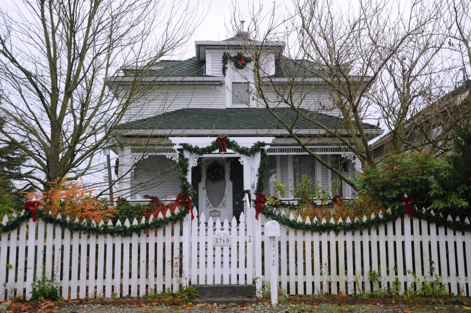 White open picket fence beside a home