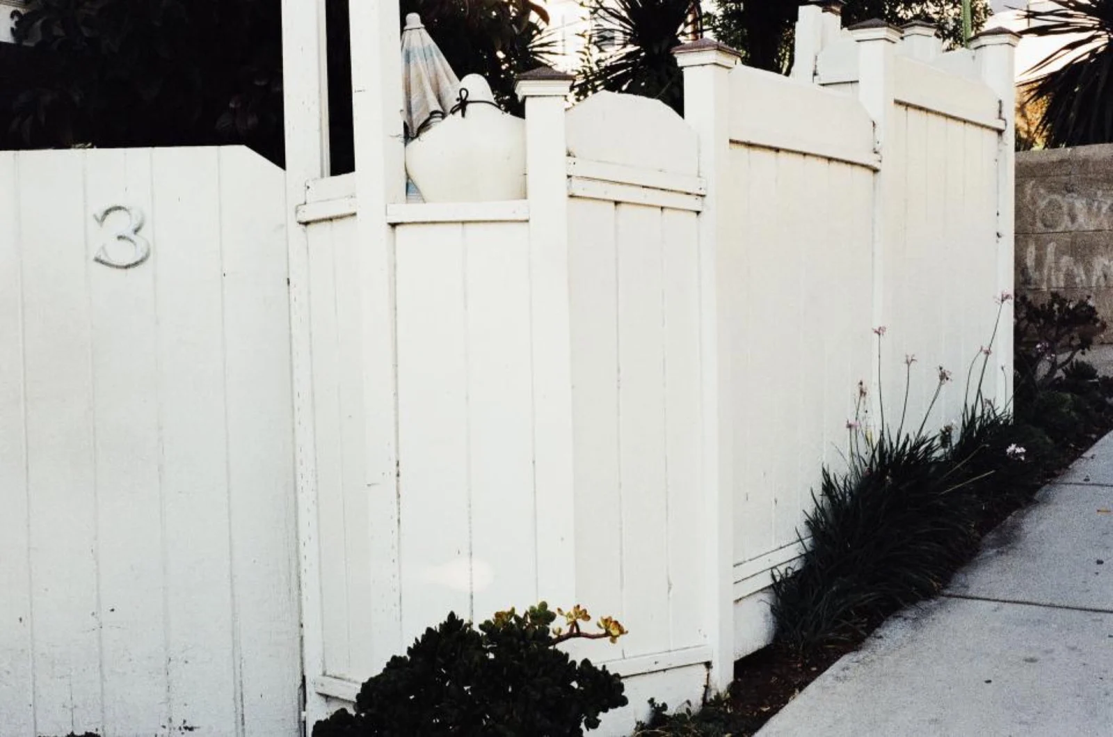 White vinyl privacy fence around a residential yard
